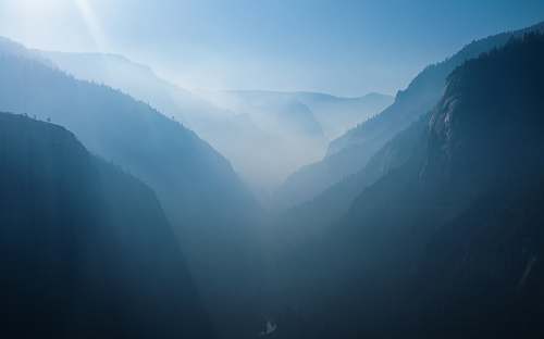mountain aerial photo of mountains covered with mist yosemite valley